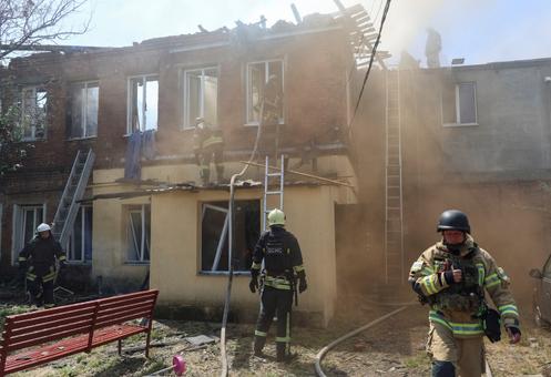 Rescuers work at the site of a Russian drone attack in Kharkiv, Ukraine, July 7, 2025.