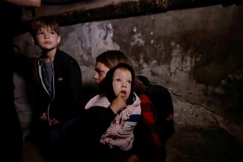 Residents take refuge in the basement of their apartment building during a Russian attack, in Kharkiv, Ukraine, July 7, 2025.
