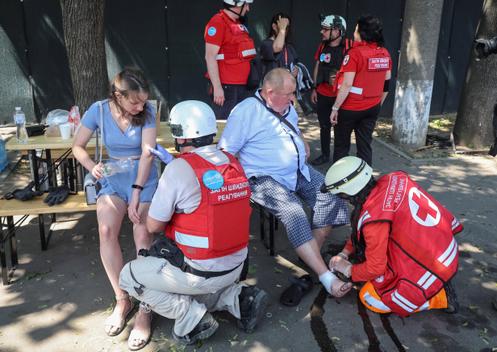 Medical workers treat residents after a Russian drone attack in Kharkiv, Ukraine, July 7, 2025.