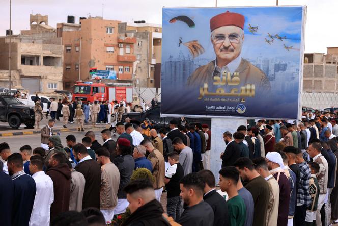 A l’occasion de l’Aïd el-Fitr, marquant la rupture du jeûne du mois de ramadan, des Libyens prient sous le portrait du maréchal Haftar, à Benghazi, le 31 mars 2025.