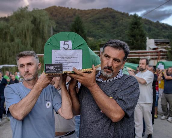 Zelda Avdic and her older brother carry their younger brother's coffin at the cemetery, the day before the Srebrenica genocide commemoration, Bosnia and Herzegovina, July 10, 2025.