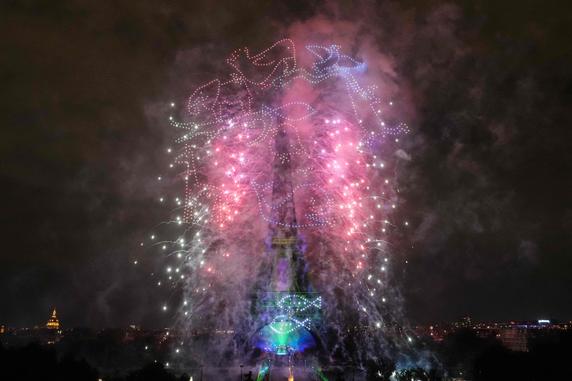 Fireworks and drones light up the Eiffel Tower in Paris on July 14, 2025.