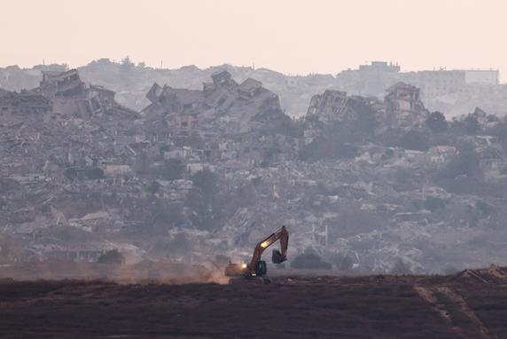 An excavator operates in the Gaza Strip, as seen from the other side of the border, on July 9, 2025.