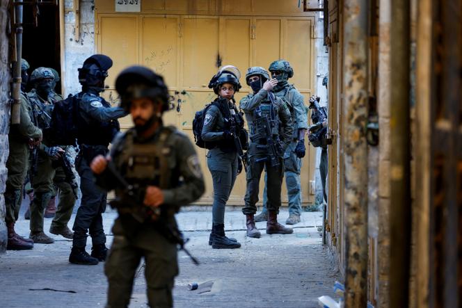 Des soldats israéliens en marge d’une visite hebdomadaire des colons à Hébron, en Cisjordanie occupée, le 19 juillet 2025.