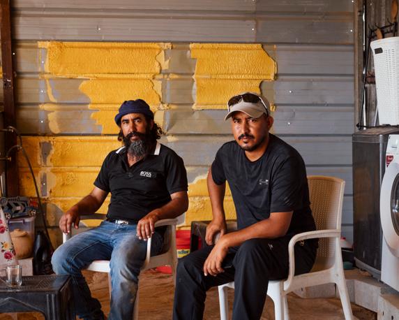Brothers Abdelatif (left), 45, and Souleiman Mleihat, 34, in their new shelter on the heights of Balqa, July 20, 2025.