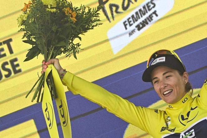 Mauritian rider Kimberley Le Court-Pienaar celebrates on the podium with the overall leader's yellow jersey after the 5th stage of the Women's Tour de France cycling race, in Gueret, central France, on July 30, 2025.