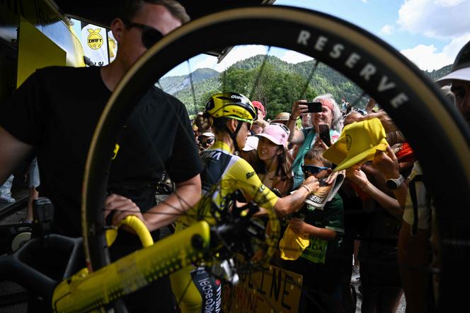 Wearing the yellow leader's jersey, cyclist Pauline Ferrand-Prévot signs autographs before the start of the ninth and final stage of the fourth edition of the Tour de France Femmes, in Praz-sur-Arly, France, on August 3, 2025.