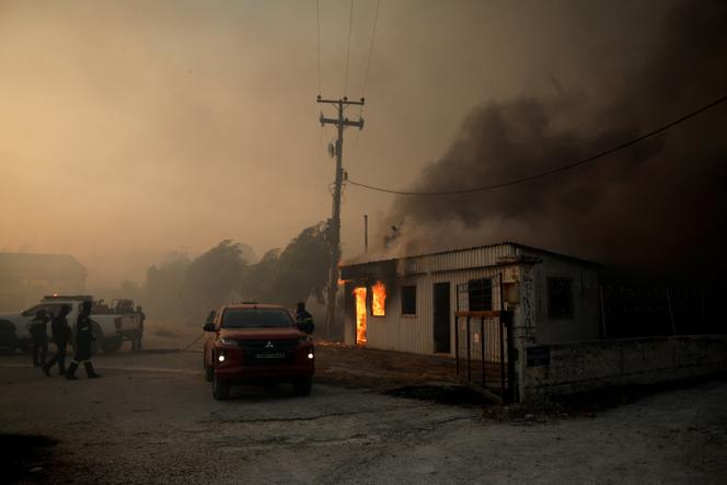 Un bâtiment en feu lors d’un incendie de forêt à Sichaina, près de Patras, en Gèce, le 13 août 2025. 
