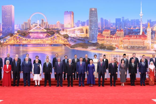 Chinese President Xi Jinping and his wife, Peng Liyuan, pose for a group photo with international guests including Russian President Vladimir Putin, Indian Prime Minister Narendra Modi and Turkish President Recep Tayyip Erdogan, before a welcome banquet for the Shanghai Cooperation Organization (SCO) Summit 2025 in Tianjin, northern China on Sunday, August 31, 2025.