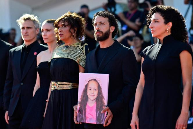De gauche à droite : Joaquin Phoenix, Rooney Mara, la réalisatrice, Kaouther Ben Hania, Motaz Malhees et Clara Khoury, avec un portrait de la jeune Palestinienne Hind Rajab pour la projection du film « La Voix de Hind Rajab », lors de la 82ᵉ Mostra de Venise, le 3 septembre 2025.