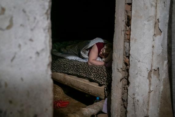 In September 2023, a Russian bombardment damaged the building where Lyudmila lived, killing three and injuring five; since then, she has slept in the building's converted basement with about 10 neighbors, Kherson, August 25, 2025.