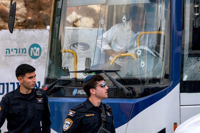 Des policiers israéliens passent devant un bus criblé de balles, sur les lieux d’une attaque à Jérusalem-Est, le 8 septembre 2025.