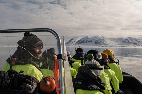 Tourists and their guide, Oliver Walberg, facing the Oscar II Land, northwest of Isfjorden, in Svalbard, on May 30, 2025.