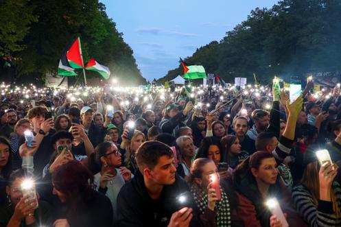 Des manifestants allument des lampes de poche sur leurs téléphones portables lors du rassemblement « Tous les regards sont tournés vers Gaza » à Berlin, en Allemagne, le 27 septembre 2025.