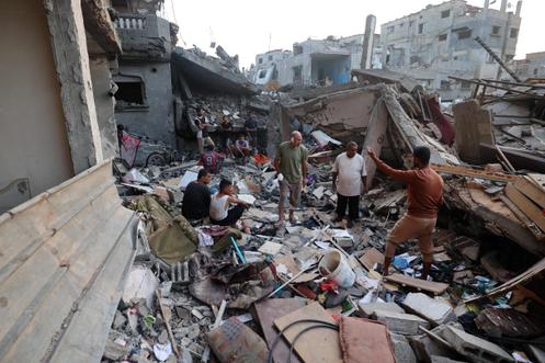 Des Palestiniens inspectent les décombres d’un bâtiment détruit par une frappe israélienne dans le camp de réfugiés de Nousseirat, au centre de la bande de Gaza, le 28 septembre 2025.
