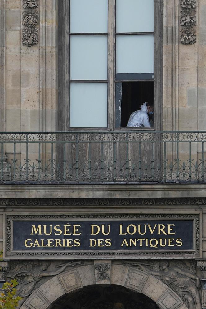 A police officer works inside the Louvre museum, Sunday, October 19, 2025 in Paris.