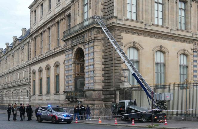 French police officers stand next to a furniture elevator used by robbers to enter the Louvre Museum, on Quai Francois Mitterrand, in Paris on October 19, 2025. 