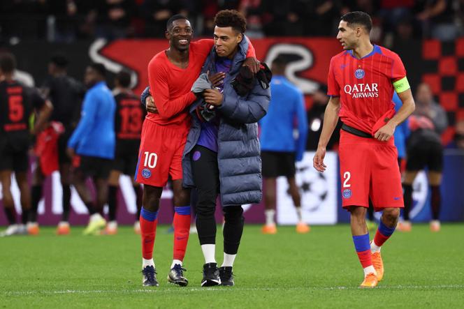 Paris Saint-Germain's Ousmane Dembélé, Desiré Doué and Achraf Hakimi celebrate after beating Bayer Leverkusen at the BayArena stadium in Leverkusen, Germany on October 21, 2025.