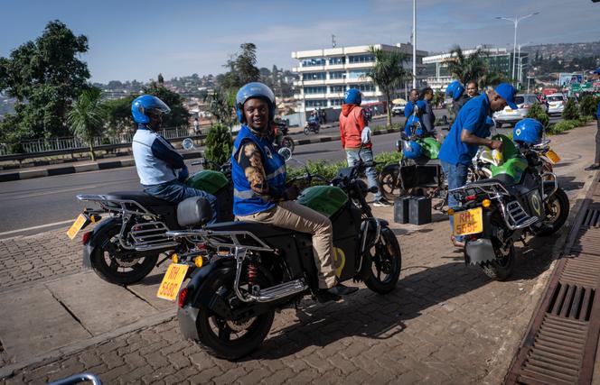 Des chauffeurs de motos-taxis électriques, au guidon d’engins fournis par la société Spiro, devant l’une des cinquante stations de recharge, à Kigali, au Rwanda, le 2 juin 2023.