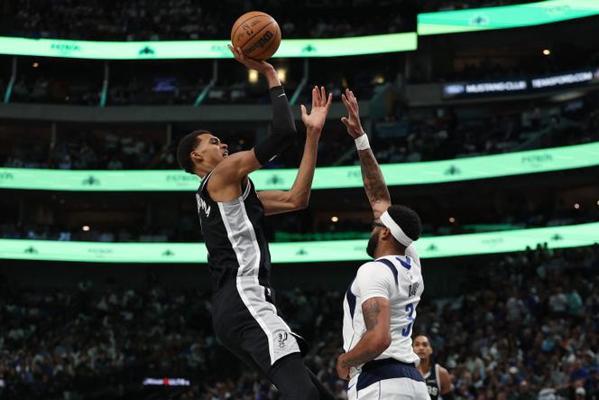 Victor Wembanyama of the San Antonio Spurs shoots over Anthony Davis of the Dallas Mavericks, on October 22, 2025 in Dallas, Texas.