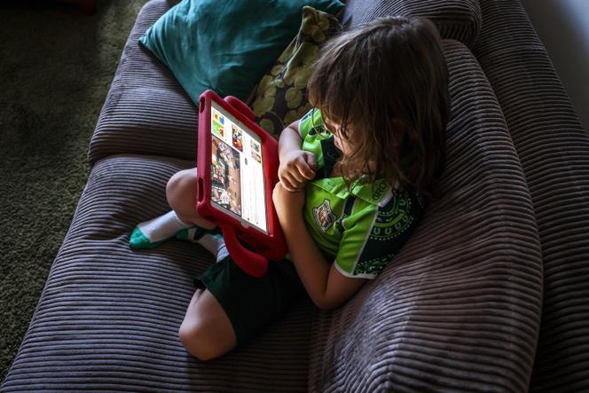 A 6-year-old child, Enrique Navarro, uses an iPad at his home in Sydney on October 30, 2025.