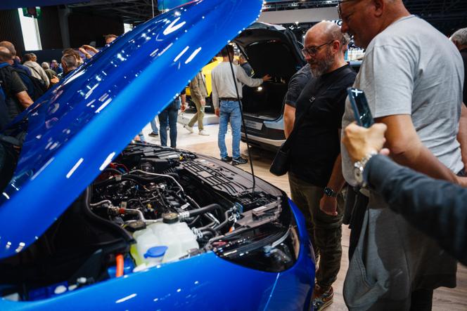 Visitors observe the Ford Puma hybrid engine presented at the Paris Motor Show, at the Paris Expo, Porte de Versailles, October 15, 2024. 