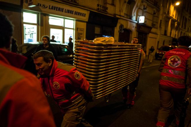 Des secouristes à proximité du Bataclan dans laquelle se déroule au même moment une attaque terroriste.  Le 13 novembre 2015, boulevard des Filles du Calvaire à Paris