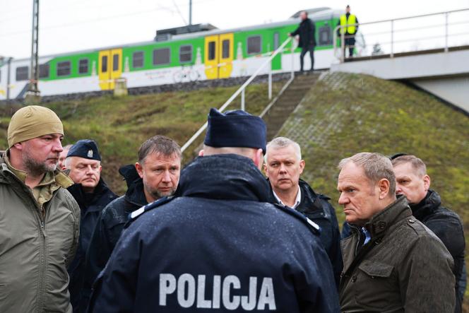 Polish Prime Minister Donald Tusk (second from right) visits the site of the Mika railway damaged by sabotage near Deblin, Poland, Monday, November 17, 2025. 