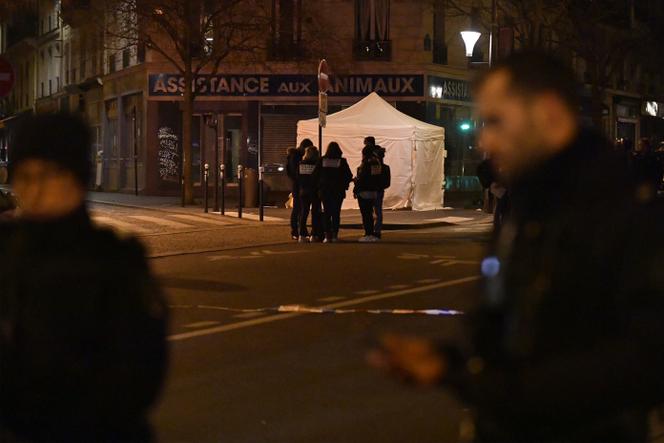 Agents from the Inspectorate General of the National Police (IGPN) investigate near where a man was shot dead by police officers earlier in the day, following “threatening behavior” towards them, according to a police source, in Paris, January 22, 2023. 
