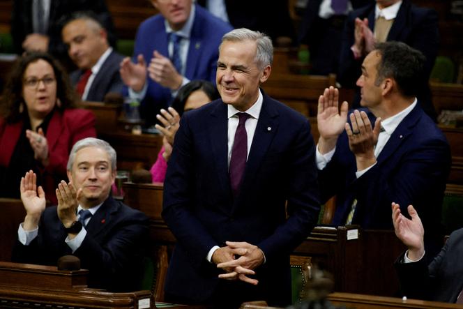 Canada's Prime Minister Mark Carney rises to vote in support of the federal budget in the House of Commons on Parliament Hill in Ottawa, Ontario, Canada, November 17, 2025. 