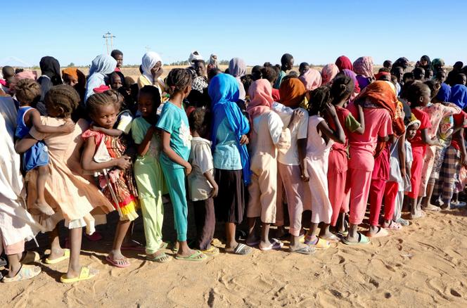 Waiting to receive aid, at a refugee camp in Al-Dabba, Sudan, November 15, 2025. 