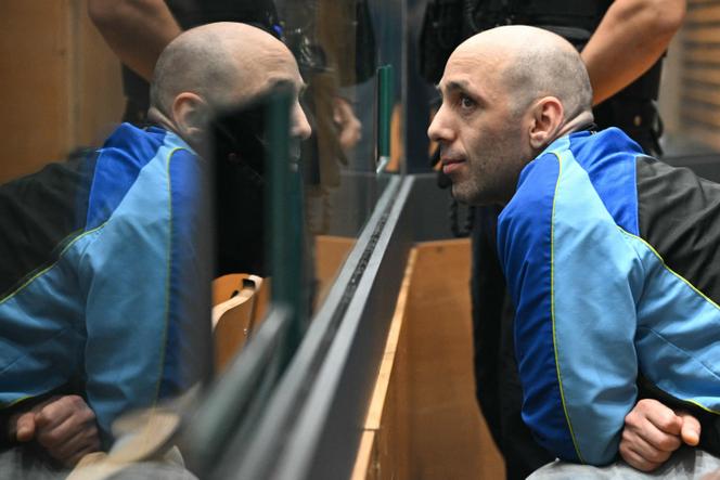(FILES) Cedric Jubillar (R), accused of causing the disappearance of his wife Delphine, reacts as he sits in the dock in the courtroom of the Tarn Assize Courthouse in Albi, southwestern France, on September 22, 2025, on the opening day of his trial.  (Photo by Lionel BONAVENTURE / AFP)