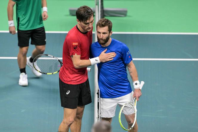 Raphaël Collignon of Belgium (left) and Corentin Moutet of France, after their Davis Cup match, in Bologna (Italy), November 18, 2025.