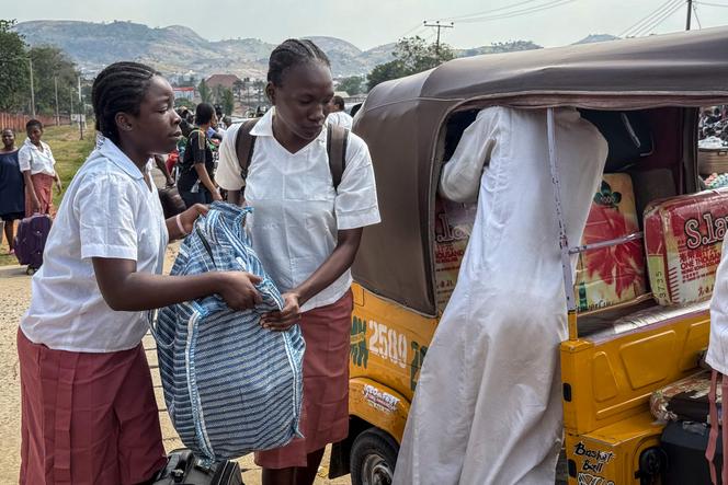 Students load bags into tuk-tuks outside the Federal Government Girls College in Bwari, a suburb of Abuja, November 22, 2025.
