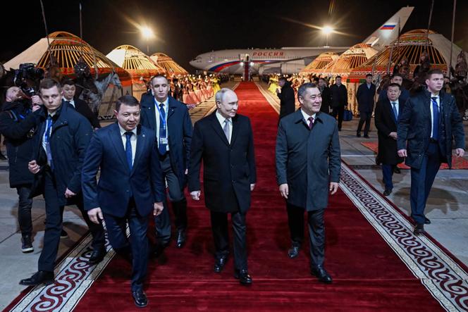 Le président kirghiz, Sadyr Japarov (à droite), accueille le président russe, Vladimir Poutine (au centre), à sa descente d’avion à l’aéroport international de Bichkek, le mardi 25 novembre 2025.