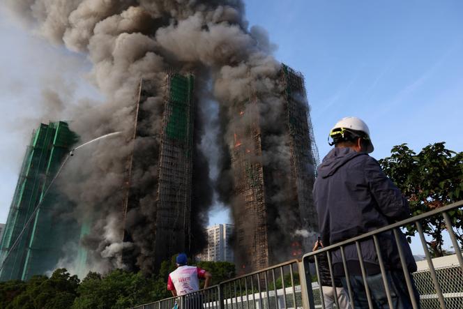 Firefighters try to extinguish a fire burning bamboo scaffolding in several buildings at the Wang Fuk Court residential complex in Tai Po, Hong Kong, China, November 26, 2025.