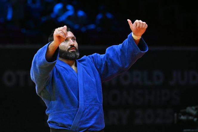 International Judo Federation's Inal Tasoev (blue) reacts in the men's +100kg final of the Judo World Championships at the Papp Laszlo Arena in Budapest, Hungary on June 19, 2025. (Photo by Attila KISBENEDEK / AFP)