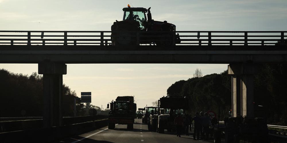 Un rassemblement d’agriculteurs qui bloquent l’autoroute A64, à Carbonne (Haute-Garonne), le 12 décembre 2025. - VALENTINE CHAPUIS / AFP