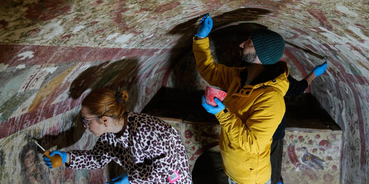Archaeologists clean and restore frescoes inside a 3rd-century tomb where a rare early Christian depiction of Jesus as the 