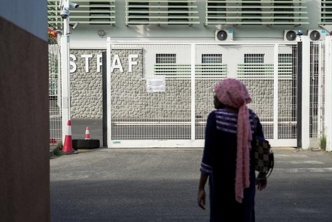 A woman waits in front of the Mayotte administrative detention center, in Pamandzi, on October 29, 2025.