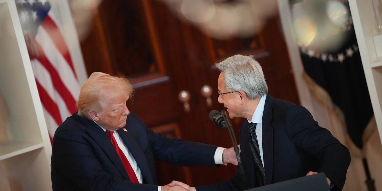  U.S. President Donald Trump shakes hands with Nvidia CEO Jensen Huang after Huang delivered remarks in the Cross Hall of the White House during an event on 