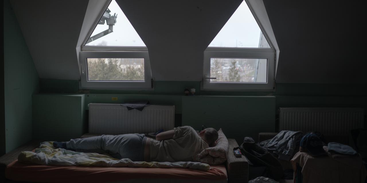 A shared living room in the “Castle” shelter with a resident who chose to remain anonymous. Vilnius, Lithuania, 16 December 2025.