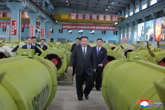 This undated picture released by North Korea's official Korean Central News Agency (KCNA) on December 26, 2025 shows North Korean leader Kim Jong Un (center) visiting major munitions industry enterprises to acquaint himself with the missile and shell production at an undisclosed place in North Korea. 