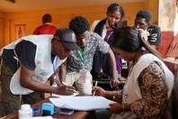 Electoral workers count votes during the presidential election at a polling station in Conakry, Guinea.
