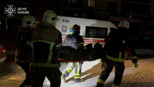 Des pompiers portent le corps d’une victime, après une frappe russe contre un hôpital, à Kiev, le 5 janvier 2026.