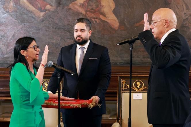 This photo released by the Miraflores Palace press office shows Venezuela's interim President Delcy Rodriguez (L) taking an oath in front of Venezuela's National Assembly President Jorge Rodriguez (R) and Deputy Nicolas Maduro Guerra (C), in Caracas, on January 5, 2026. 