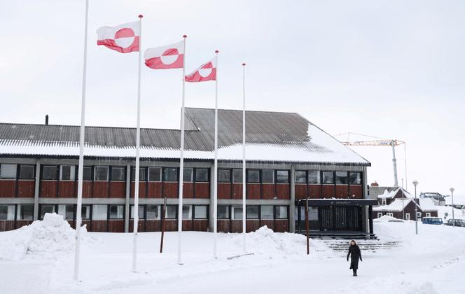 A woman walks past Greenland's parliament Inatsisartut in Nuuk, Greenland, March 28, 2025. 