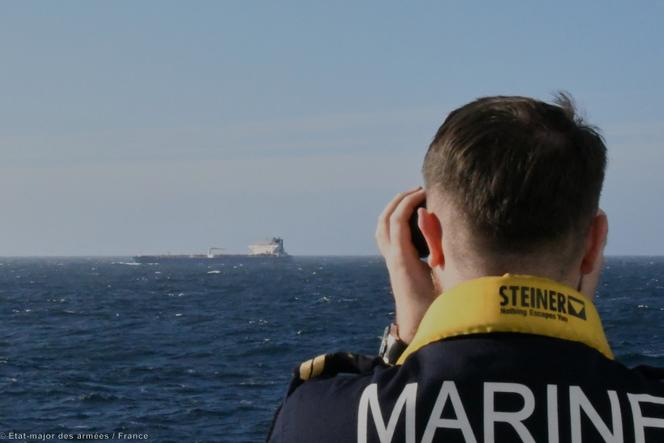 An image issues by the French armed forces shows a naval officer observing an oil tanker thought to be part of the shadow fleet Russia uses to evade Western-imposed sanctions over its war in Ukraine, January 22, 2026.