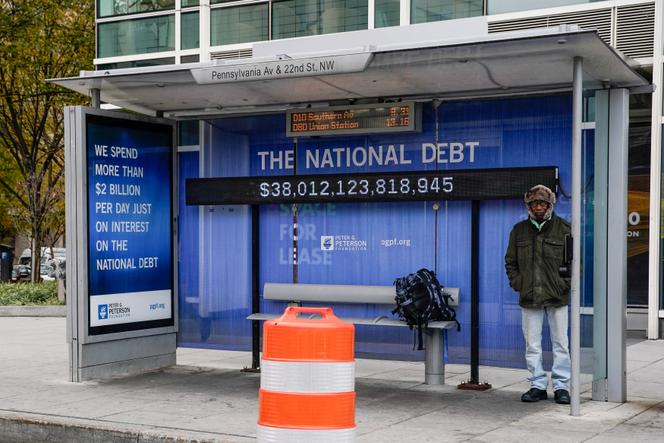 Vue d’un abribus où est affichée la dette nationale américaine, par habitant et pour l’ensemble du pays, à Washington, le 28 octobre 2025.