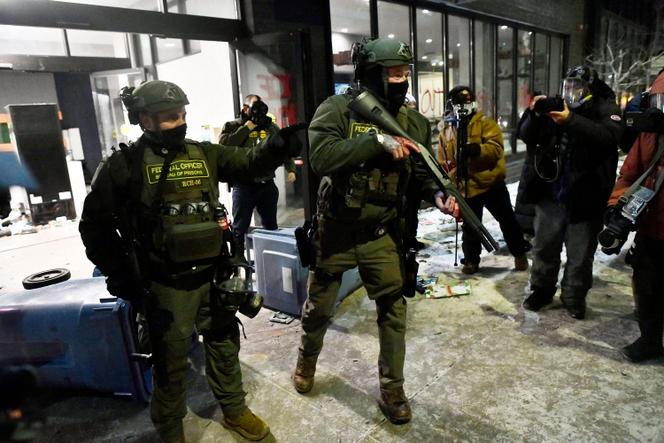 Des agents fédéraux repoussent des manifestants lors d’une manifestation contre l’ICE (Immigration and Customs Enforcement) devant un hôtel à Minneapolis, (Minnesota), le 25&nbsp;janvier&nbsp;2026. 